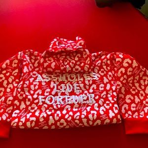 Party sweater from assholes live forever